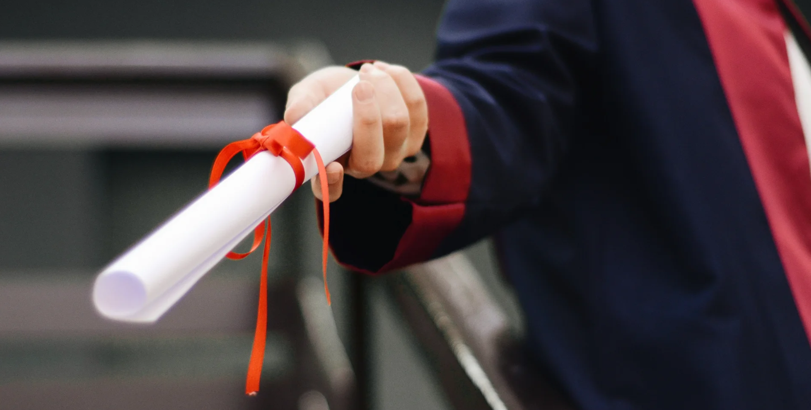 Student holding graduation diploma